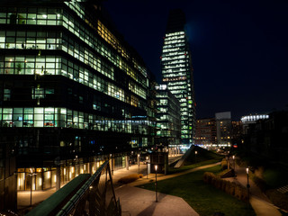 Fototapeta na wymiar Milan's financial district offices lit up late at night. Italy