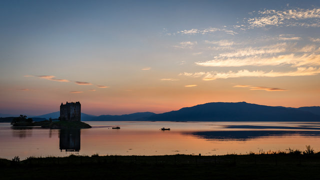 The picturesque Castle Stalker on tidal island in Loch Laich at sunset, Scotland
