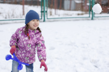 Children play snowballs with the first snow