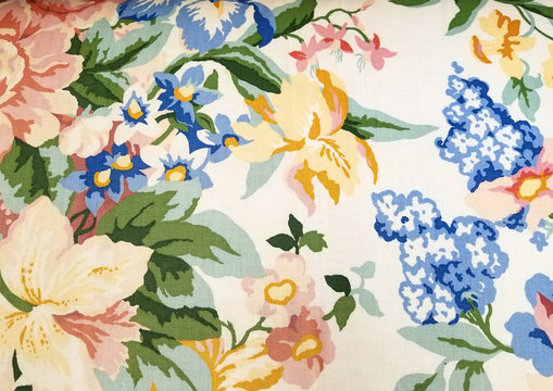 close up of colorful retro floral fabric pattern with yellow iris and blue flowers