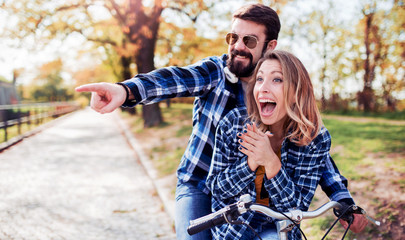 Couple in love. Romantic couple riding a bicycle in the park. Love, dating, romance