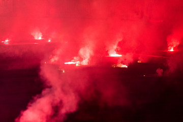 Obraz na płótnie Canvas red torch on a football stadium