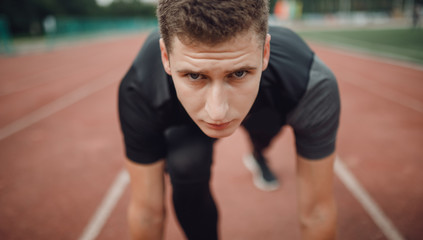 Athlete view of runner man on treadmill is ready to win.