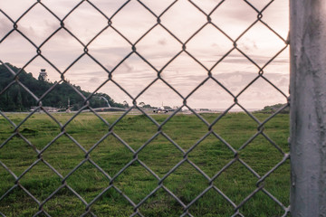 wire mesh steel with green grass background in Phuket Thailand