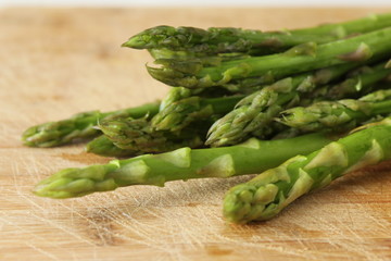 Asparagus close up on wooden chopping board