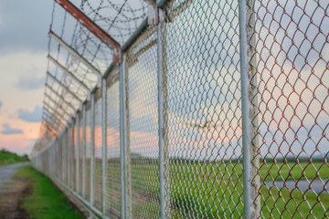 wire mesh steel with green grass background in Phuket Thailand