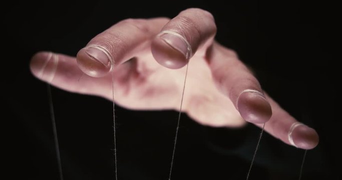 Puppeteer with manipulating hands controlling all your moves. Concept
