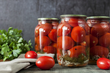 Homemade canned tomatoes in glass jars. Close-up photo
