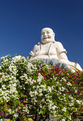Large white Buddha statue at Buddha temple property in My Tho, Vietnam
