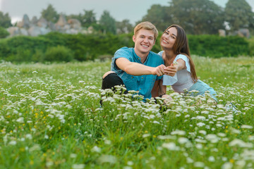 Fototapeta premium Young couple gives flowers