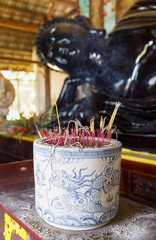 Incense smoke in a large pot in Buddha temple in the city of Da Lat, Vietnam