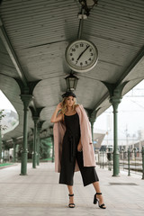 Pretty young girl posing at train station