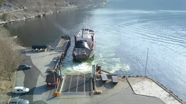 Decending Drone Shot of a Ferry Preparing to Unload Cars at a Dock on a Fjord in Norway