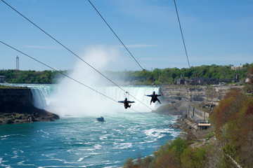 NIAGARA FALLS, ONTARIO, CANADA - MAY 21st 2018: Two people taking zipline ride at Niagara Falls in...