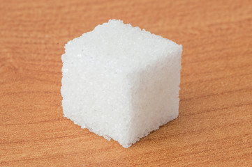 Close up the sugar cube on wooden table.