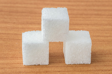 Close-up of sugar cubes wooden table.