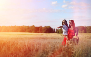 Young girl in a wheat field. Summer landscape and a girl on a na