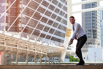 Fototapeta premium Businessman playing golf with cityscape on the background