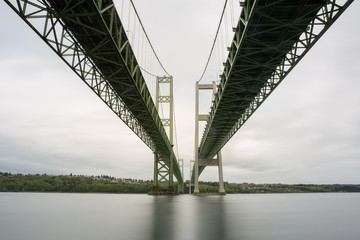 Under the Tacoma Narrows Bridge with a long exposure of river