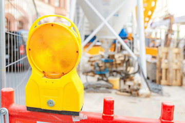 Fototapeta premium Construction site is protected by fence with flashing light