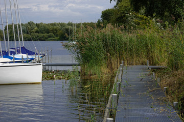 Naklejka premium Yachts moored on calm lake