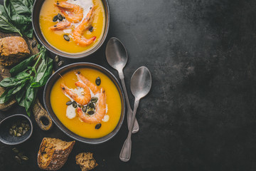 Fototapeta na wymiar Autumn pumpkin creamy soup in bowls