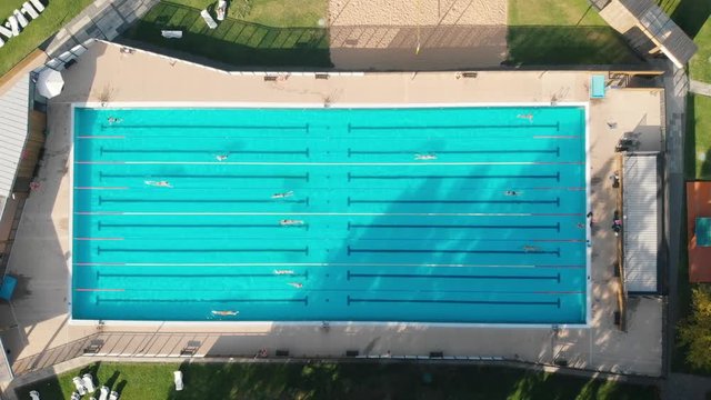 Swimmers practice in olympic pool in Moscow aerial vertical shot