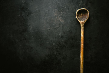 Old spoon on dark table