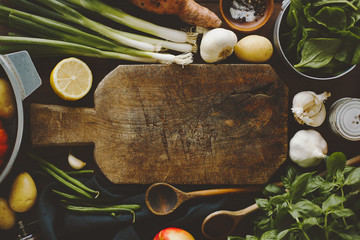 Fresh vegetables with board on wooden table