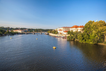 Fototapeta na wymiar View to Vitava river from Charles Bridge in Prague, beautiful summer day