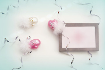 Wooden frame, shiny multicolored decorative mittensshiny serpentine, background, flat lay with place for your text. Abstract christmas background, copy space