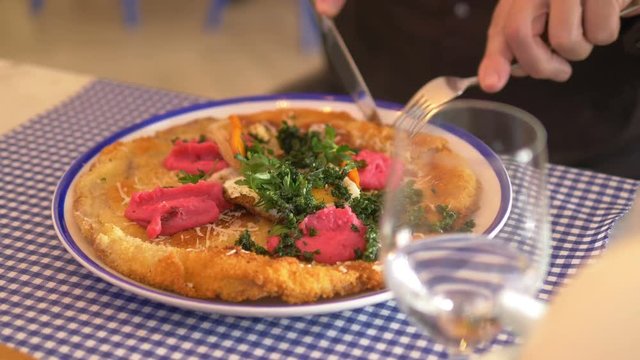 Man taking photos of schnitzel dinner by smartphone in 4k slow motion 60fps
