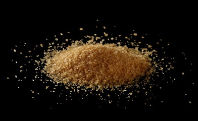 Brown sugar, pile isolated on black background, sugarcane