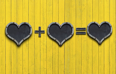 love shape blackboard hanging against wooden wall