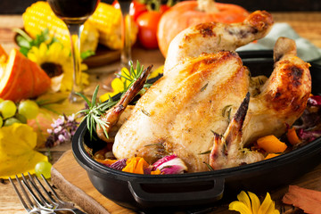 Thanksgiving Day food concept. Homemade Roasted Turkey with Pumpkin and red wine in glasses on rustic background.
