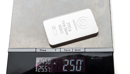 Silver bar 250 grams in weight on an electronic scales.