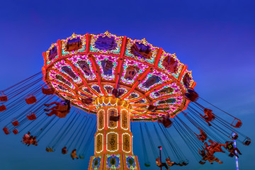 Illuminated Swing Carousel during Blue Hour 
