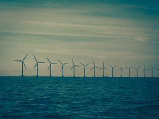 Wind turbines power generator farm along coast sea