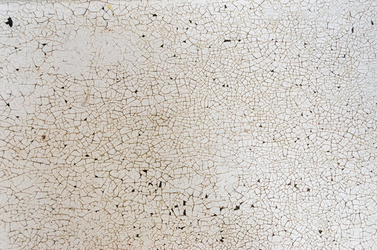 Textured background of a bright cracked white painted surface