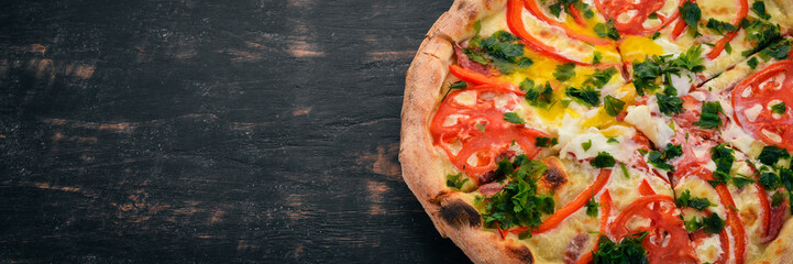 Pizza with vegetables and poached egg. Italian cuisine. On a wooden background. Free space for text. Top view.