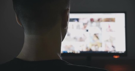 Young Man secretly watching porn sites at night.