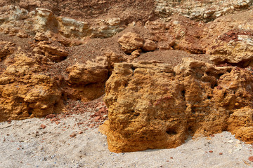 closeup of stone on the beach, sea coast with high hills, beautiful wild landscape