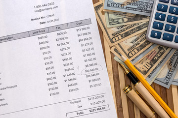 Checked purchase order with pen, calculator and dollars