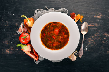 Vegetable soup kharcho. On the old wooden background. Free space for text. Top view.