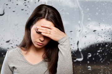 Young woman crying on background