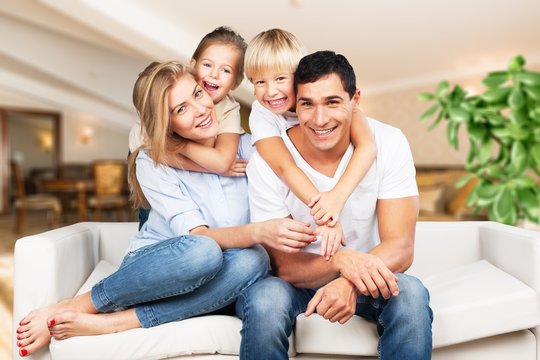 Young  family at home smiling at camera