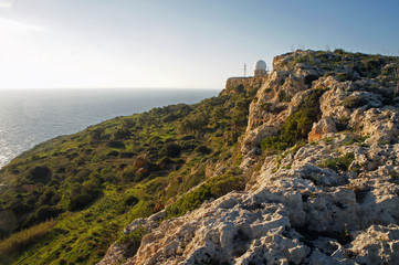 Fototapeta na wymiar Dingli Cliffs with Dingli Aviation Radar building in the sunset, Malta