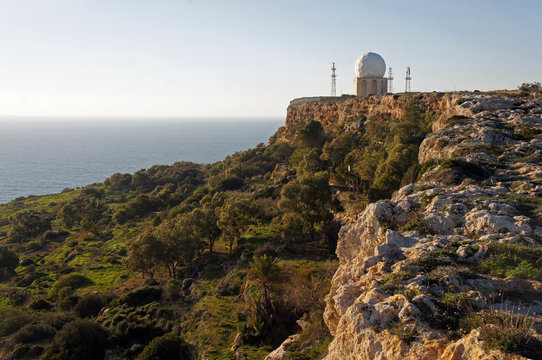 Dingli Cliffs with Dingli Aviation Radar building in the sunset, Malta