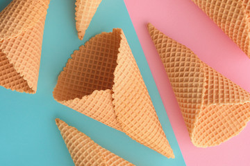 Ice cream waffle cones on pastel pink and blue background