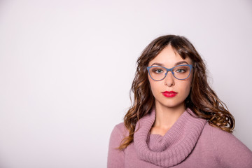 Obraz premium Beauty sexy fashion model girl wearing blue glasses, isolated on white background.young brunette woman with trendy accessories posing in studio.glasses with a blue frame.Health, good vision